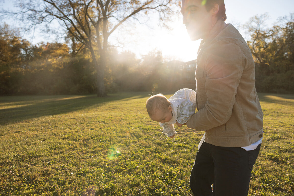 Father plays with infant in the golden sunset hour in Nashville, TN.