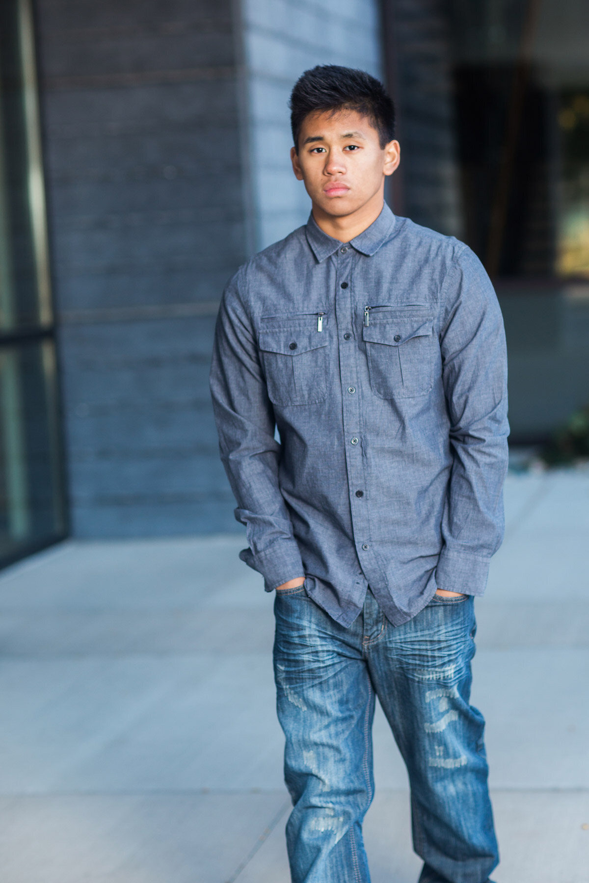 Boy walking down street for senior pictures in Daybreak Utah.