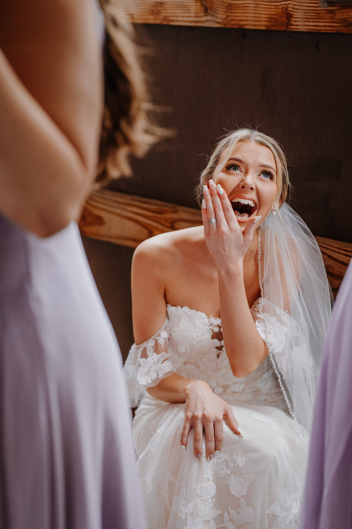 Bride in wedding dress sitting laughing