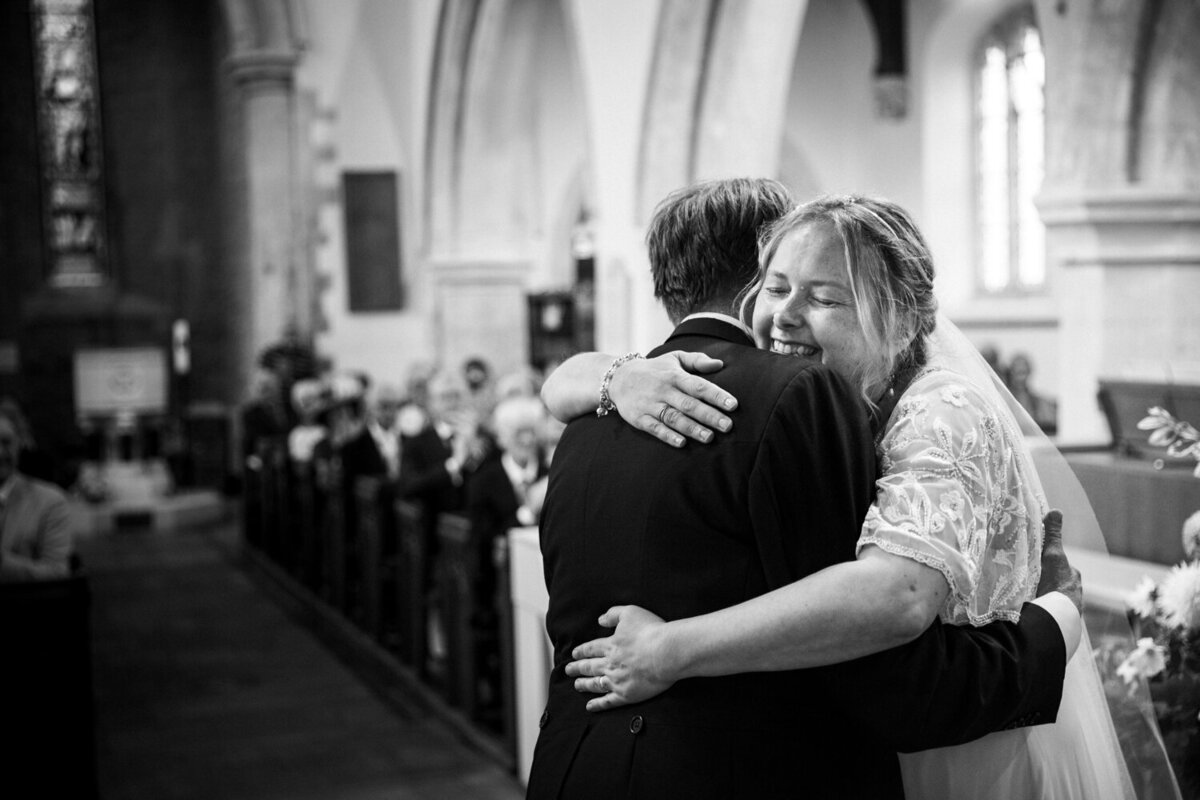 bride hugging groom during ceremony