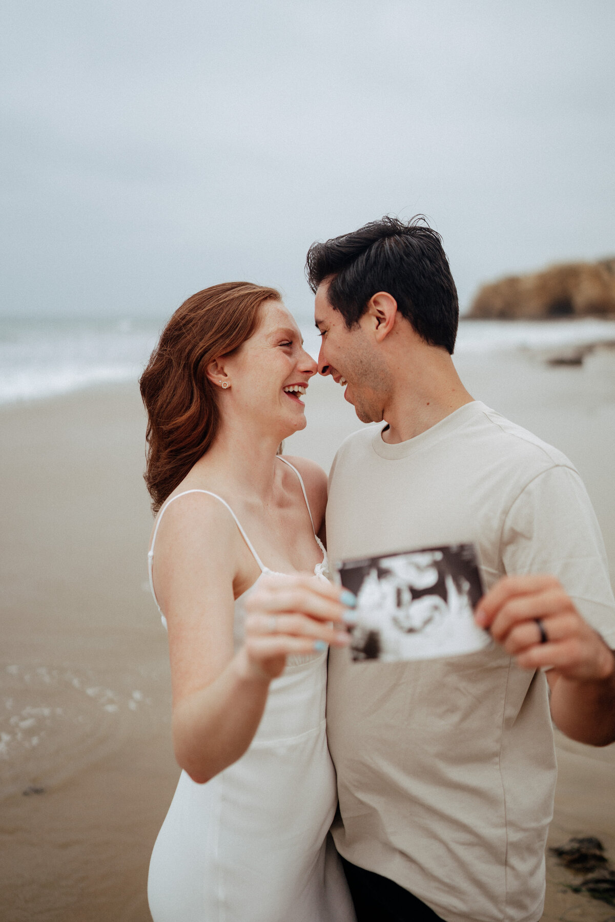 couple shoot for maternity session during golden hour Oregon coast beach wedding/elopement - photographed by The Storytellers