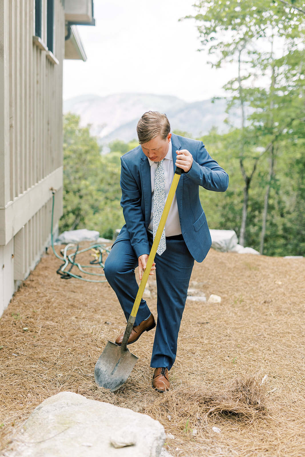 Groom digs up a buried bourbon bottle as part of the Southern good-weather wedding tradition.