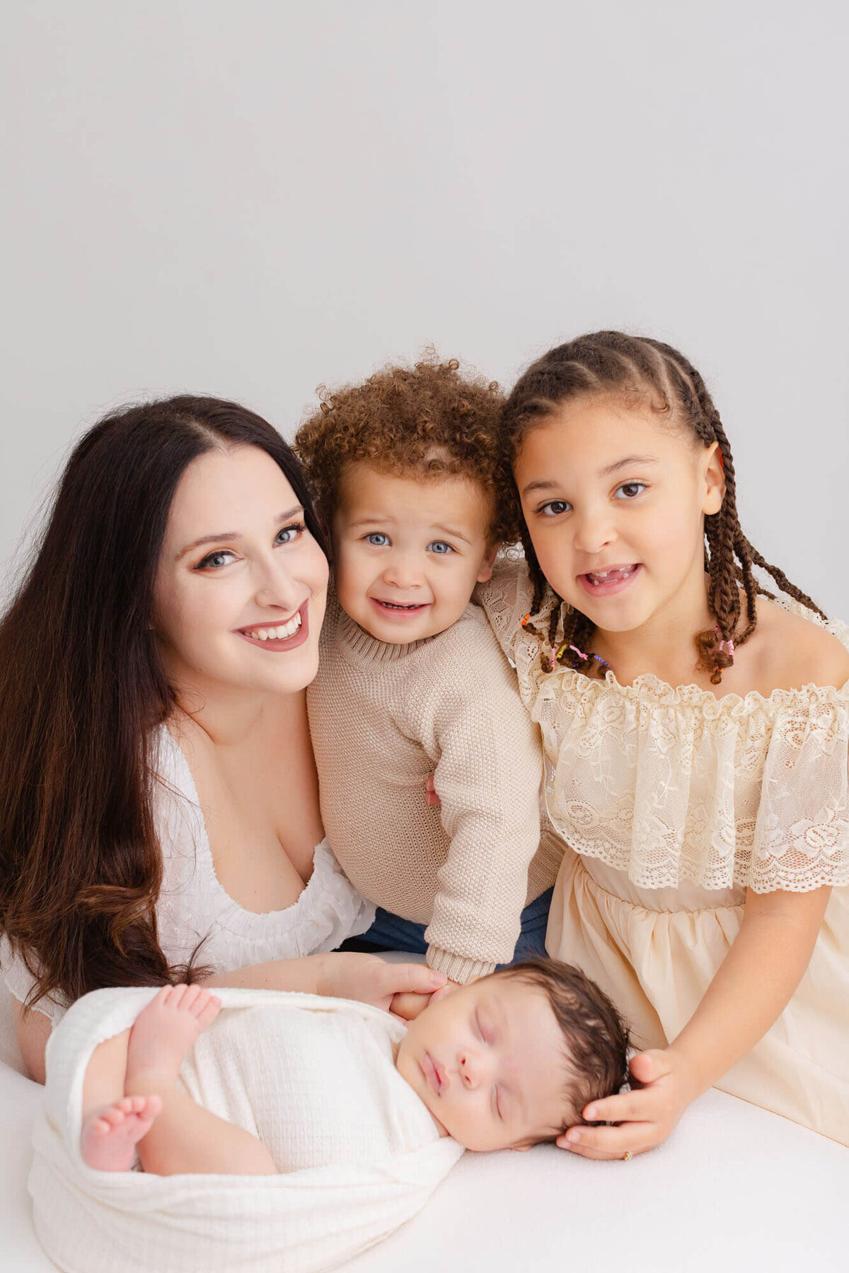 Mom with her three babies during her youngest's newborn photo session in Portland, Oregon.