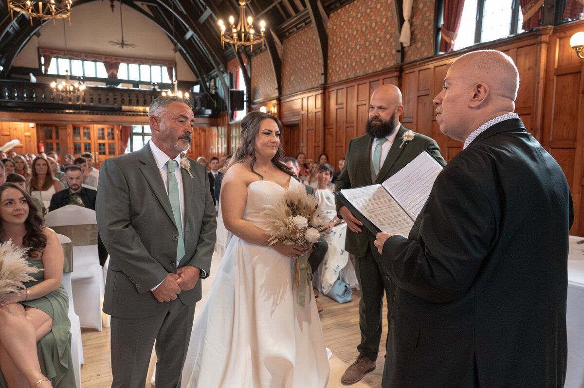 Bride and groom exchanging vows in Worsley Court House ceremony room.