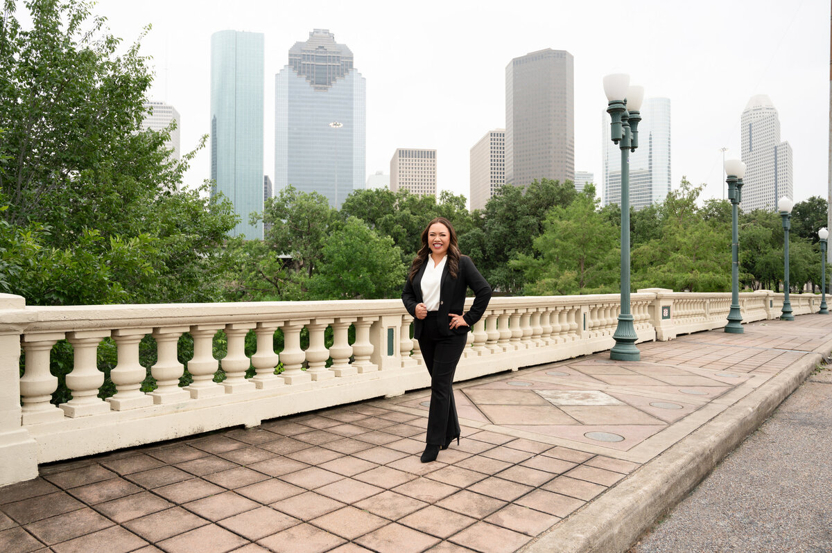 Branding portrait of Marilly Mendez on Houston bridge during golden hour