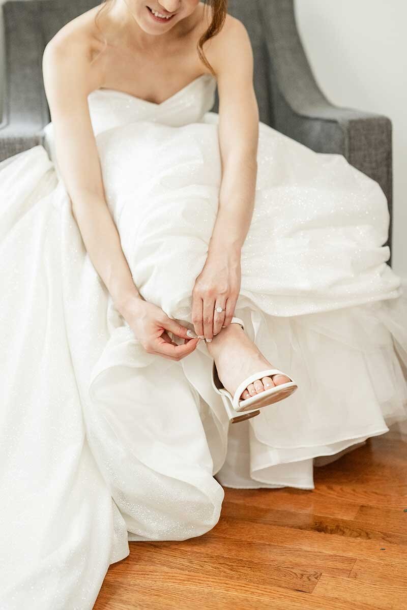 Bride Putting on Shoes-Connecticut Wedding Photographer