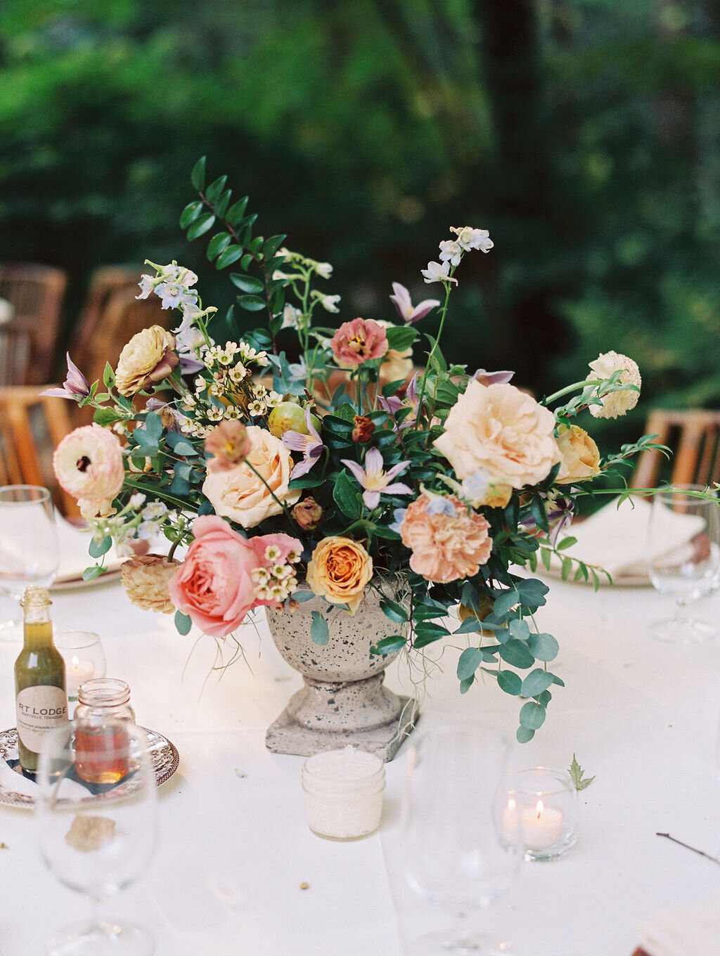 Romantic autumn floral centerpiece with candles, garden roses and lush natural greenery. Wedding floral design at RT Lodge by Rosemary and Finch in Nashville, TN.