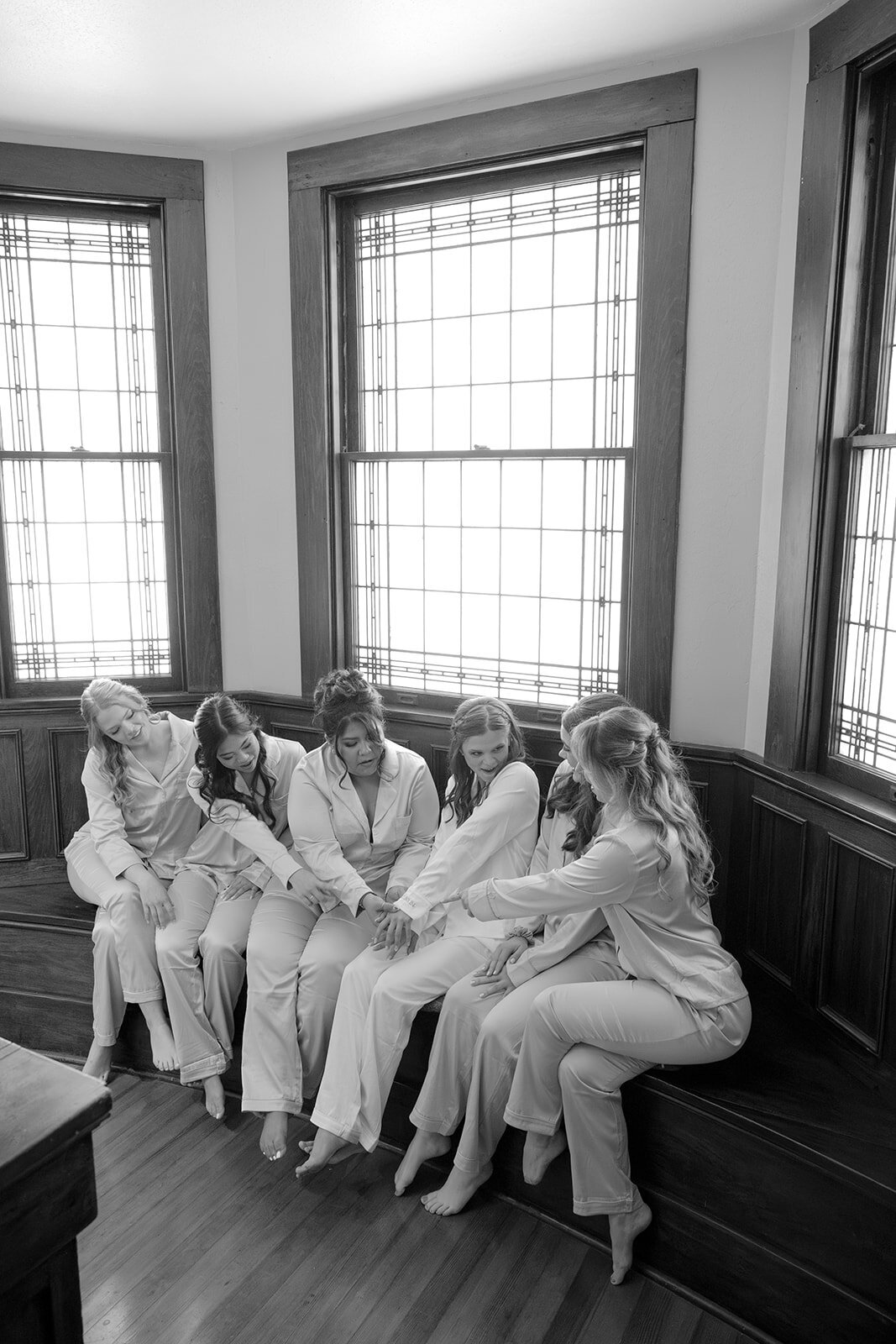 Editorial pre-ceremony image of bridal party in robes by large window at San Antonio wedding venue