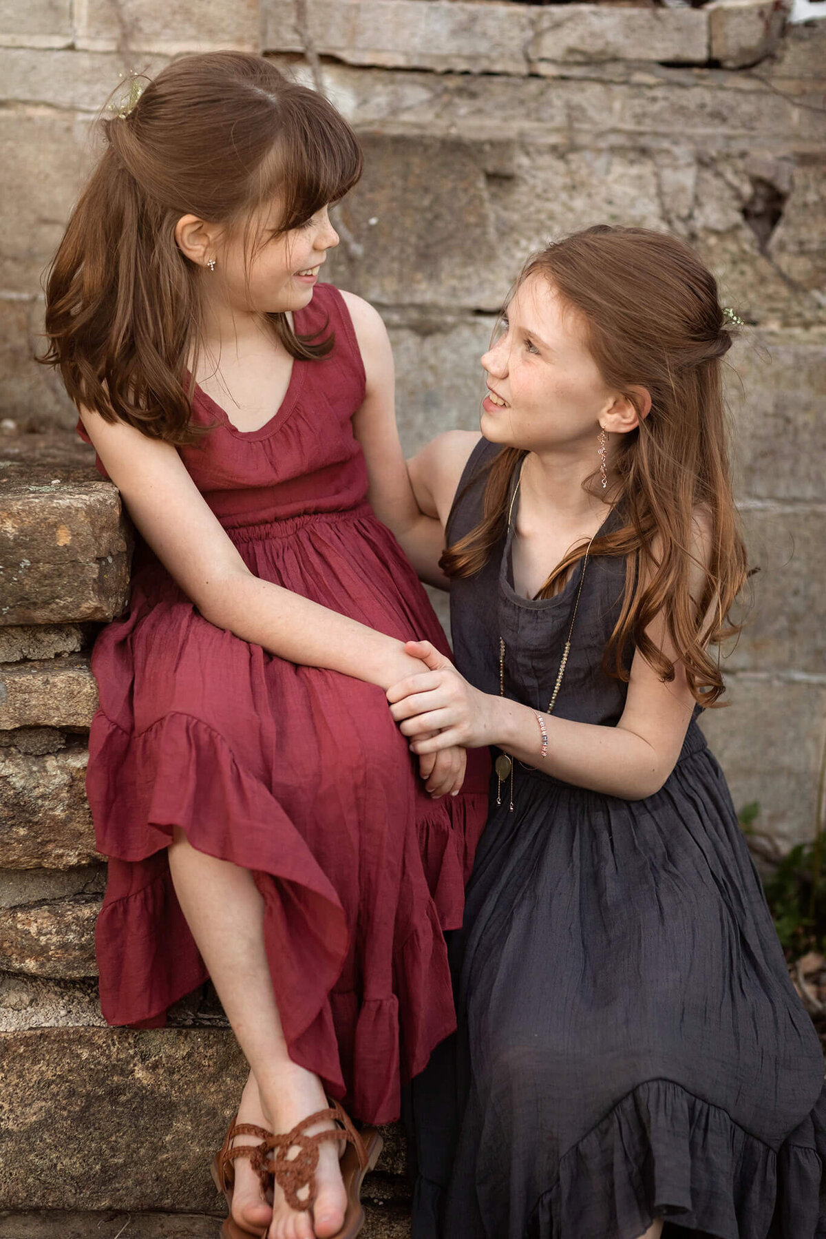 NJ portrait photos of two sisters holding hands and telling secrets