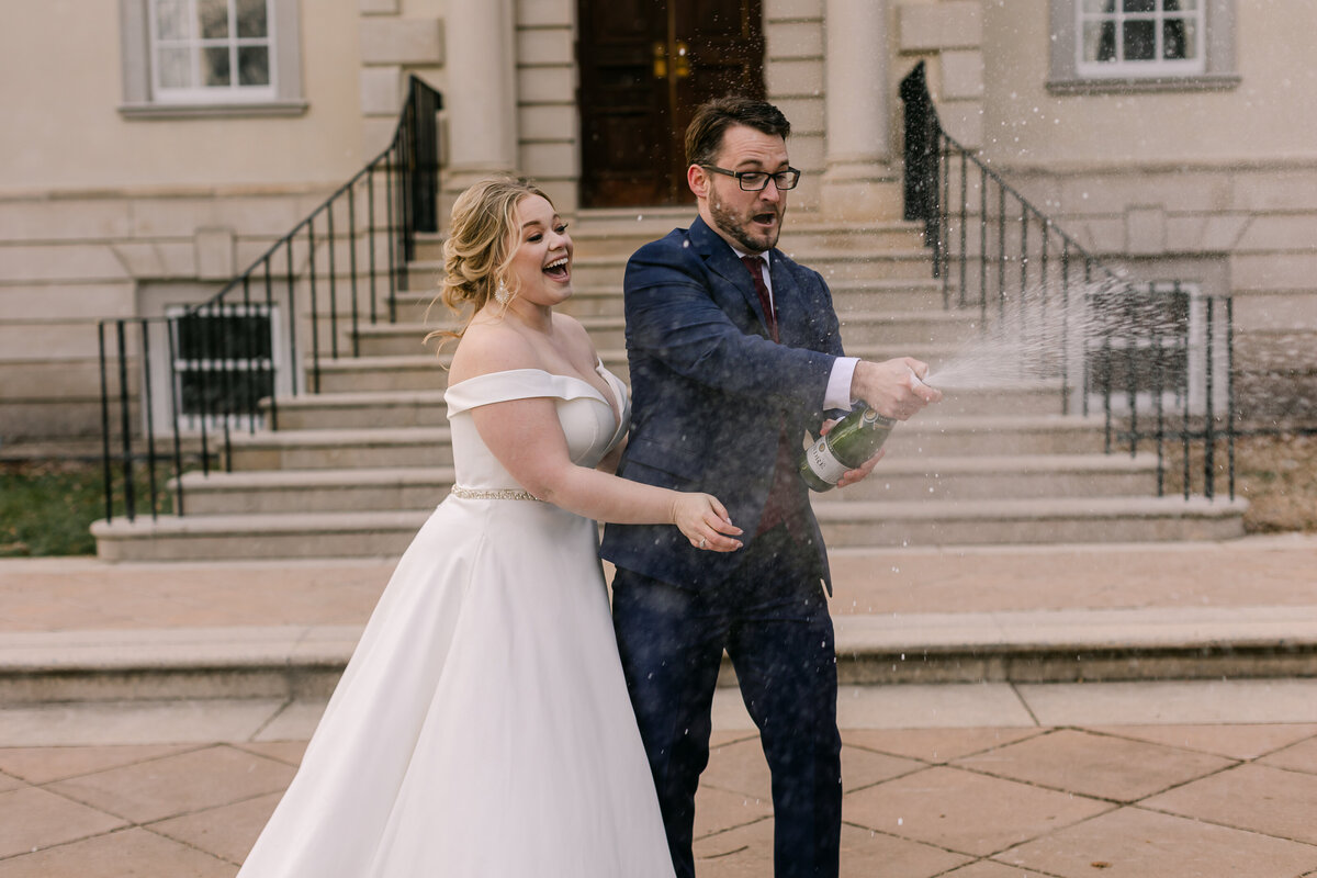 Wedding Photographer, a bride and groom spray champagne in the streets