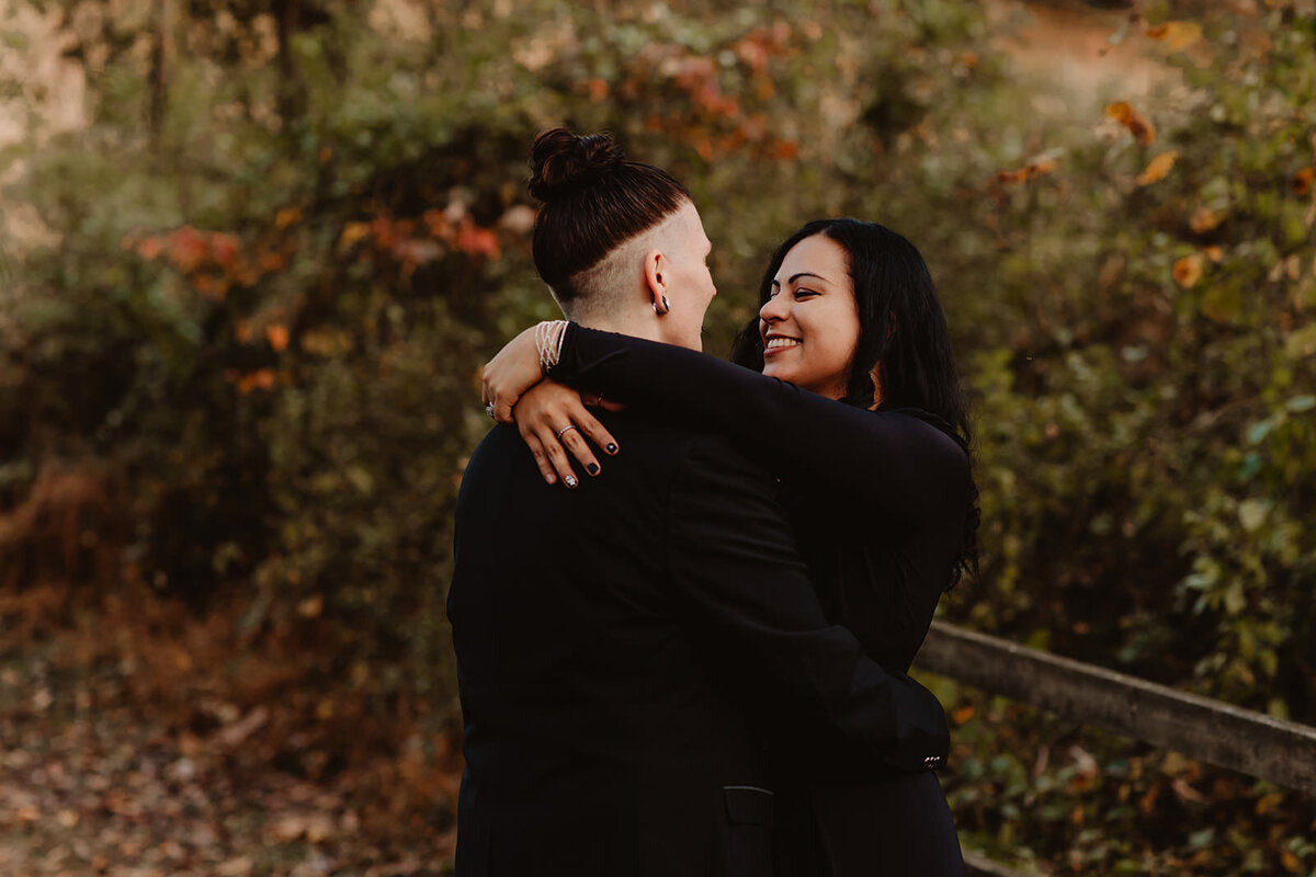 A couple kissing as they look at each other and smile 