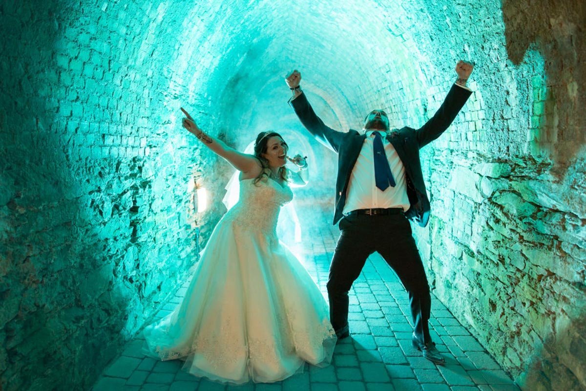 Bride and Groom celebrating in the Tunnels at Tunnels Beaches Devon