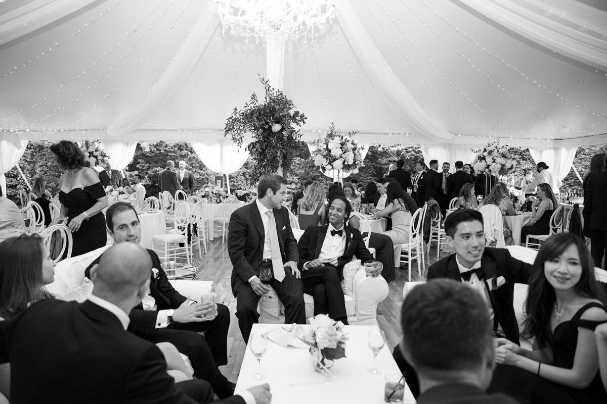 Guests enjoy lounge seating during wedding reception.