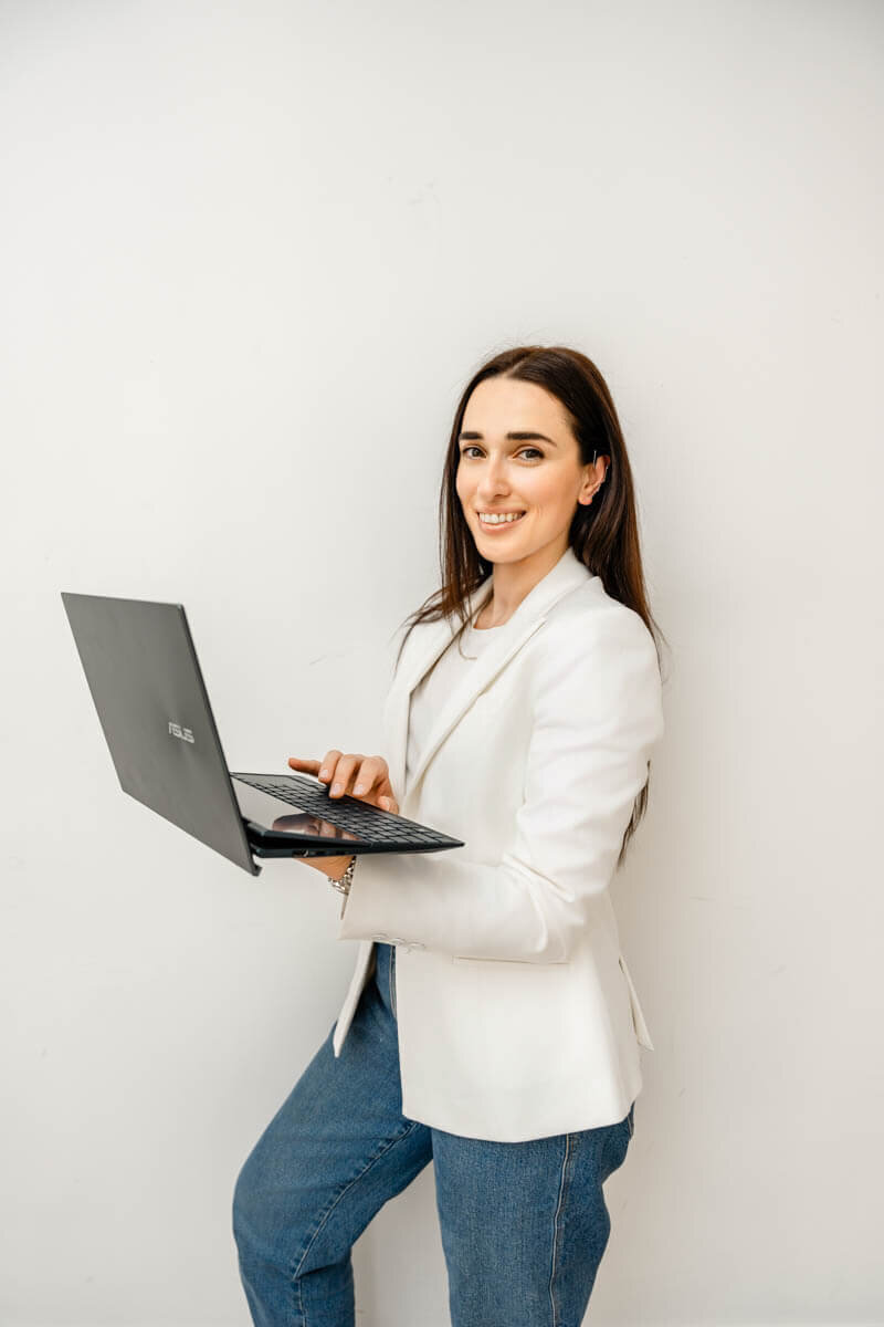 a business coach holding a laptop taken by a personal branding photographer in baltimore