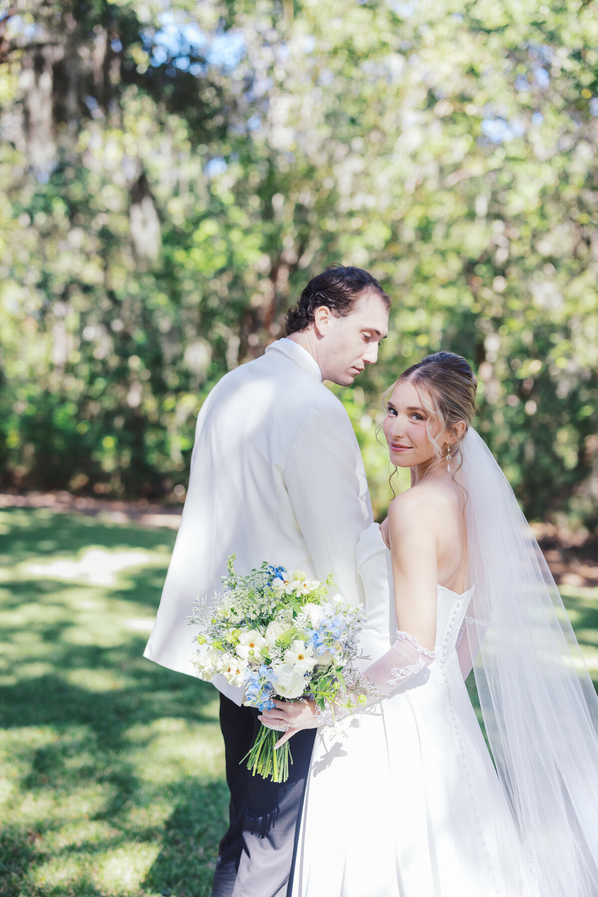 Bride looks back at camera during wedding portraits