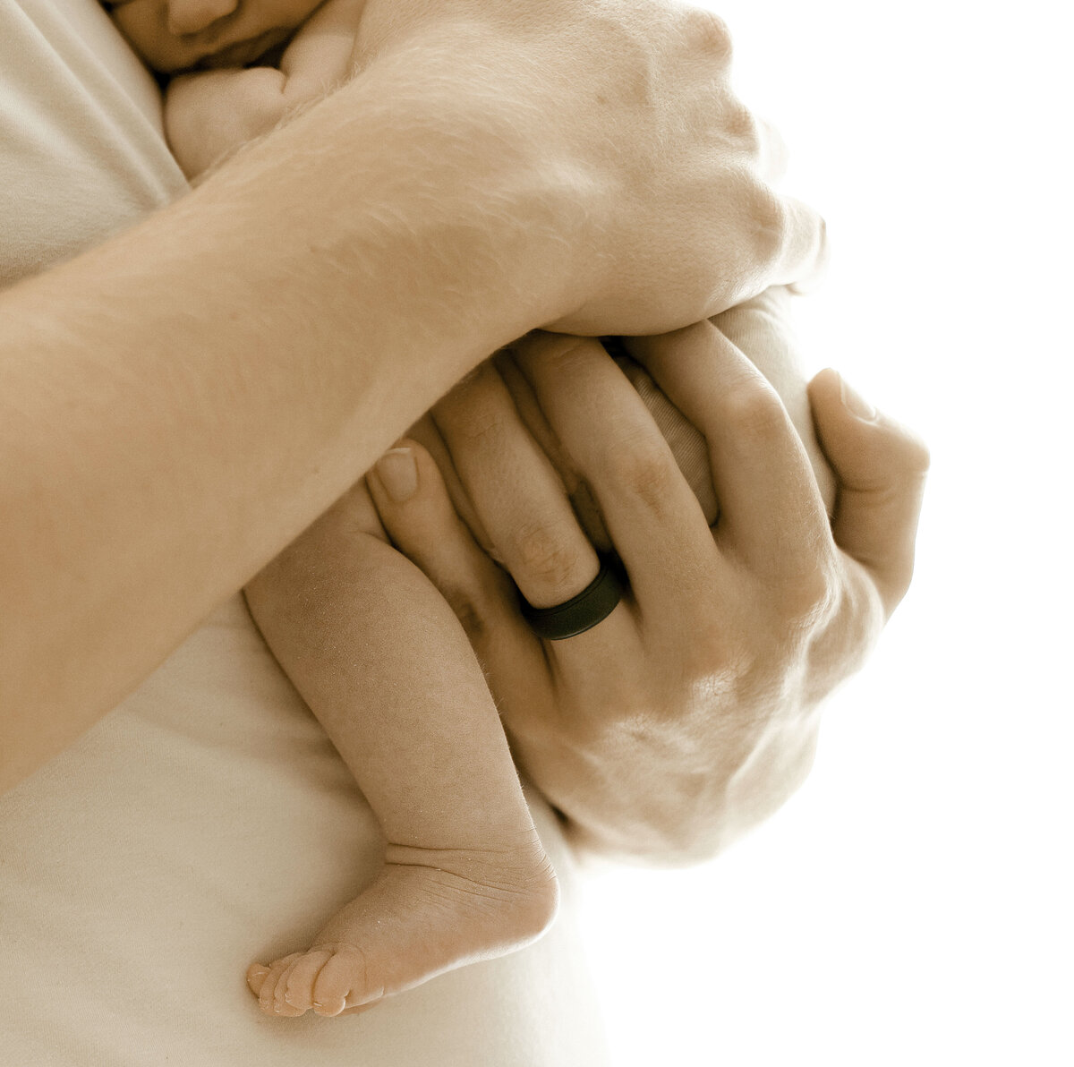 dads hands holding tiny newborn during Asheville Newborn Photo Session