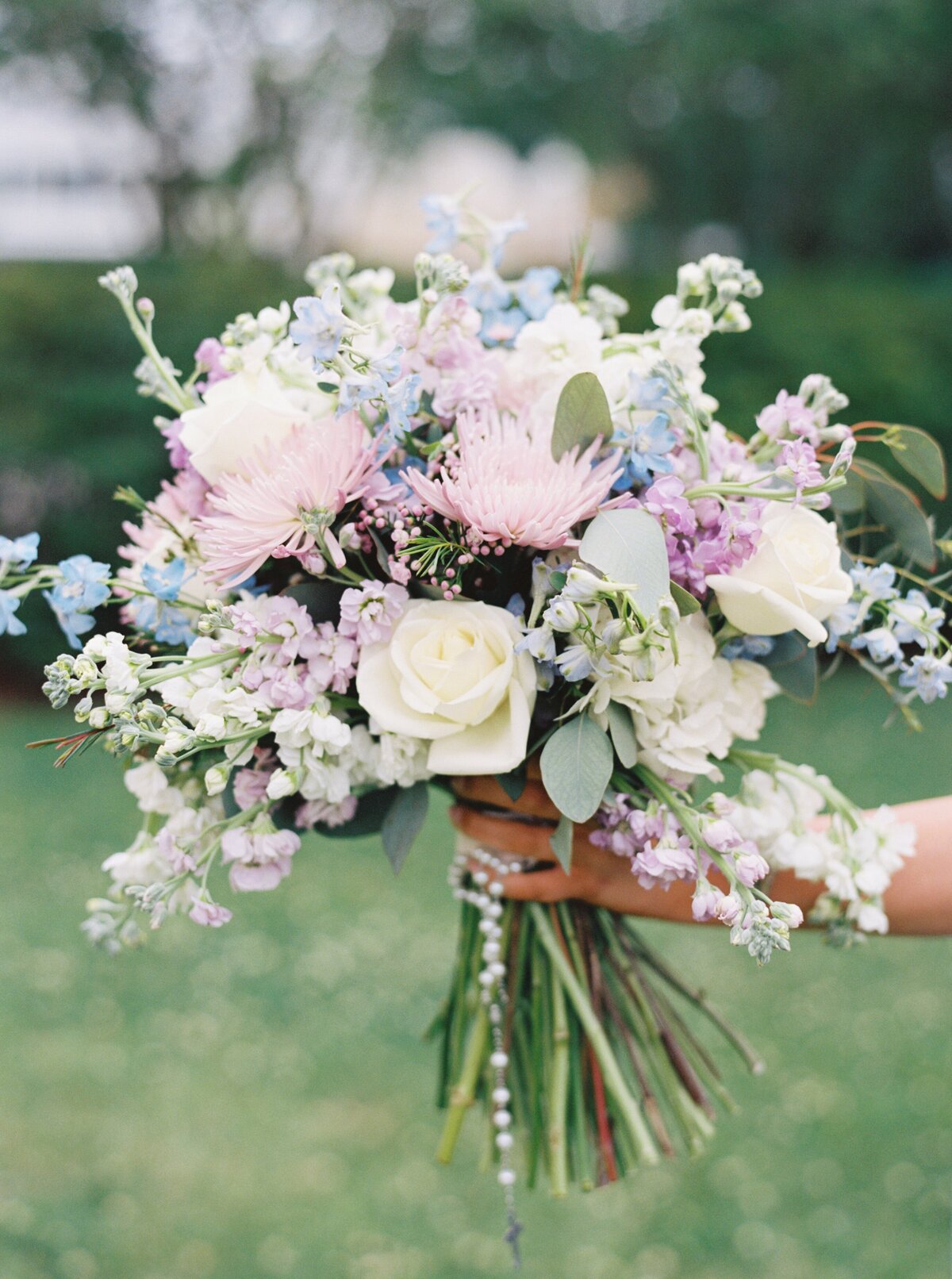 A stunning bouquet of lilac and blue blooms, bringing a soft, romantic touch to the wedding day, beautifully captured on film by Morgan Alysse, Louisiana film photographer.
