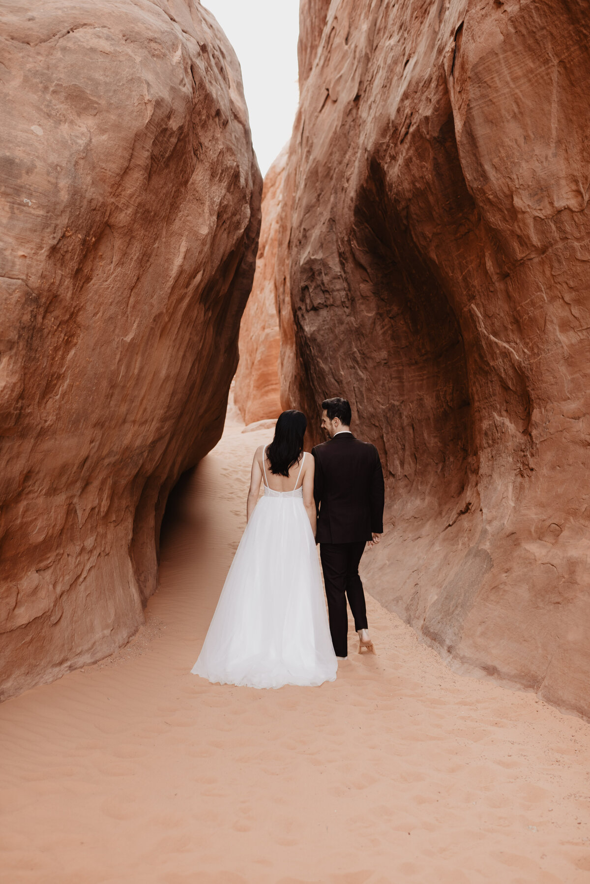 Utah elopement photographer captures couple walking barefoot