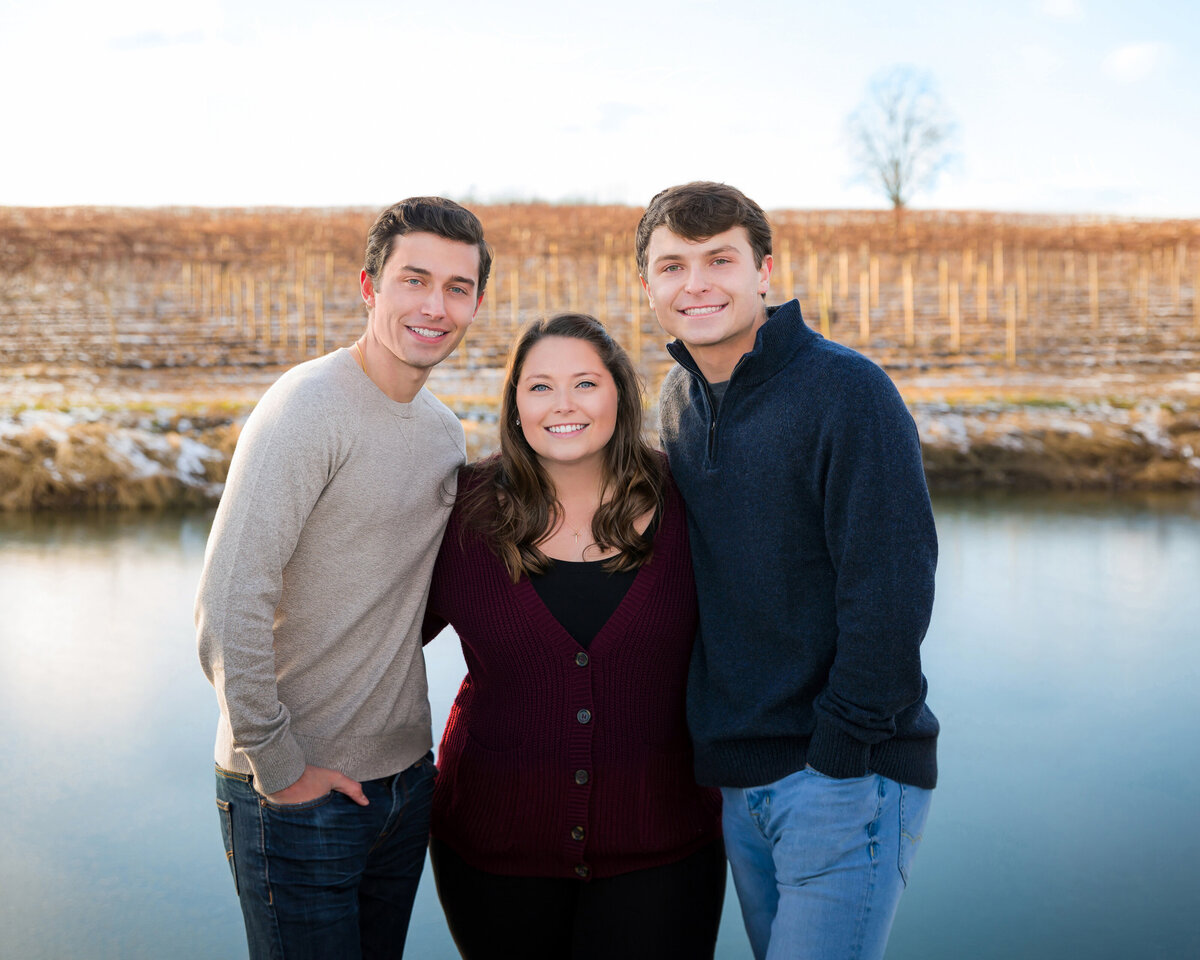 Beautiful winter portrait of 3 siblings by a pond in Penn Yan, NY