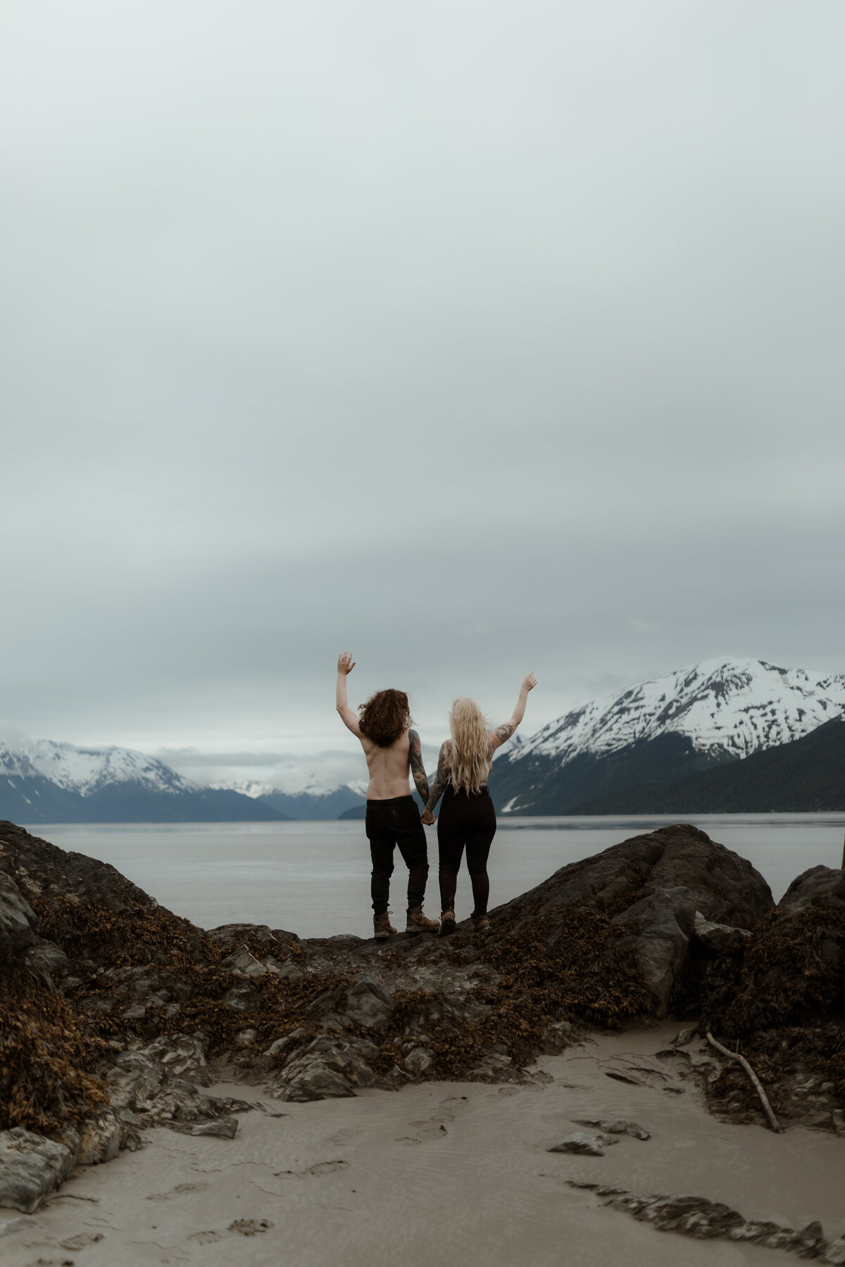 couple cheering in mountains