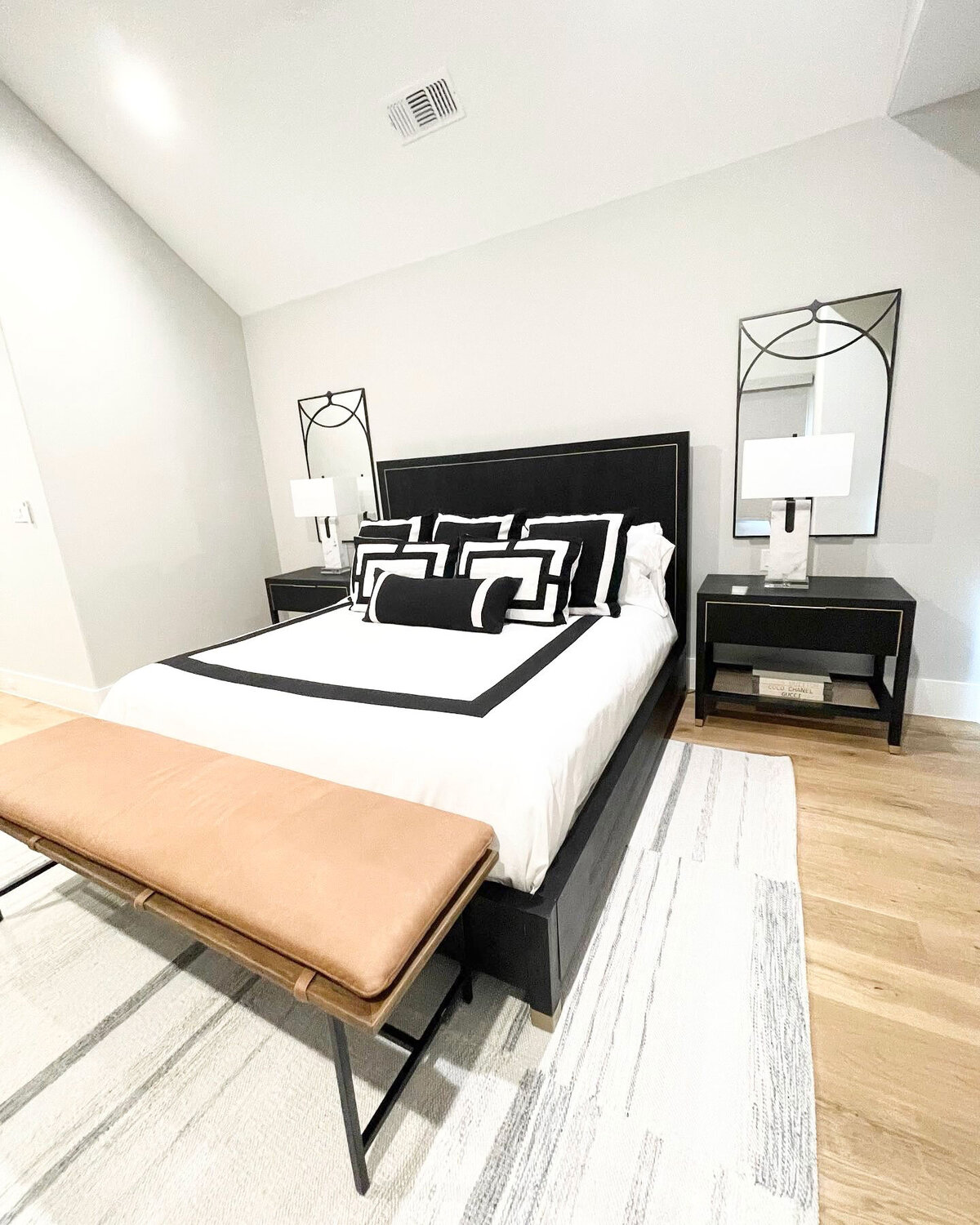Modern home interior design for a bedroom project featuring classic black and white decorations, creating a sleek and elegant atmosphere.