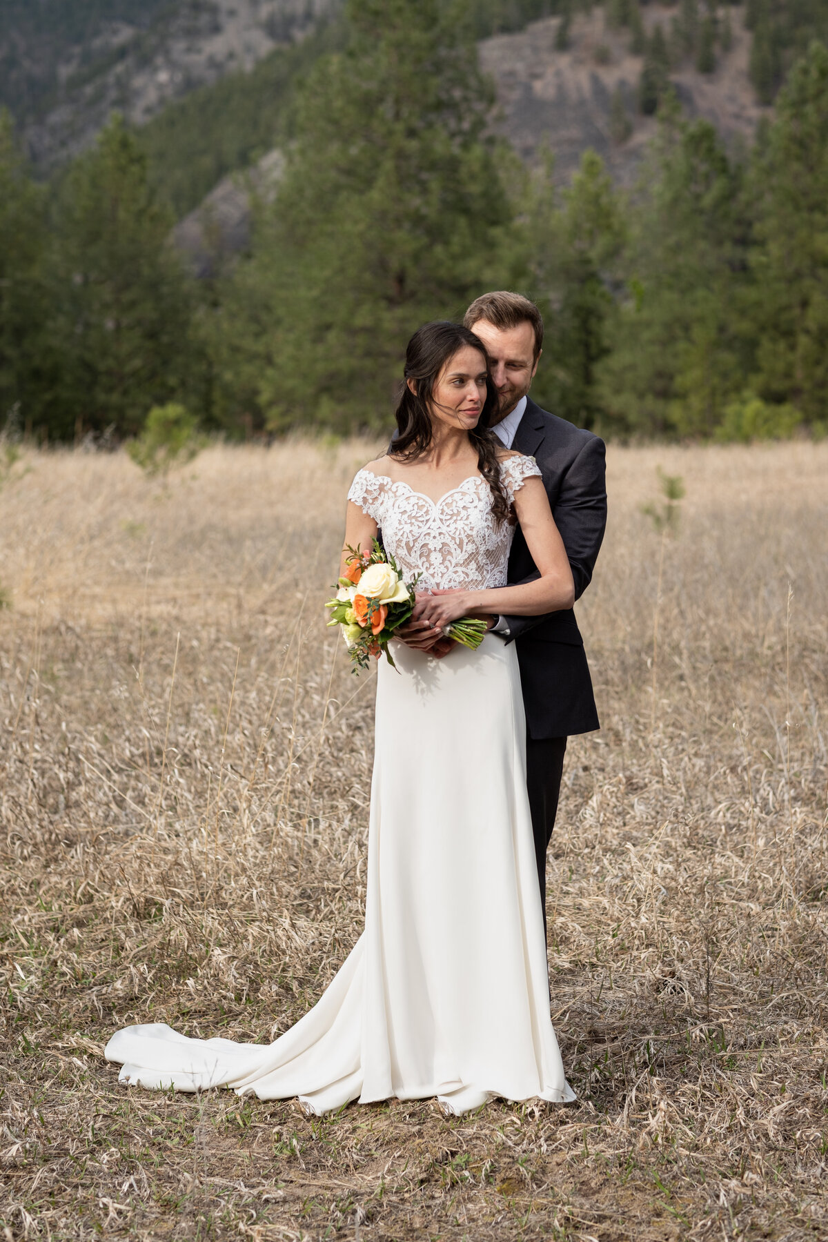 husband and wife - couples photography - man wrapping arms around women - man kissing women - groom holding bride