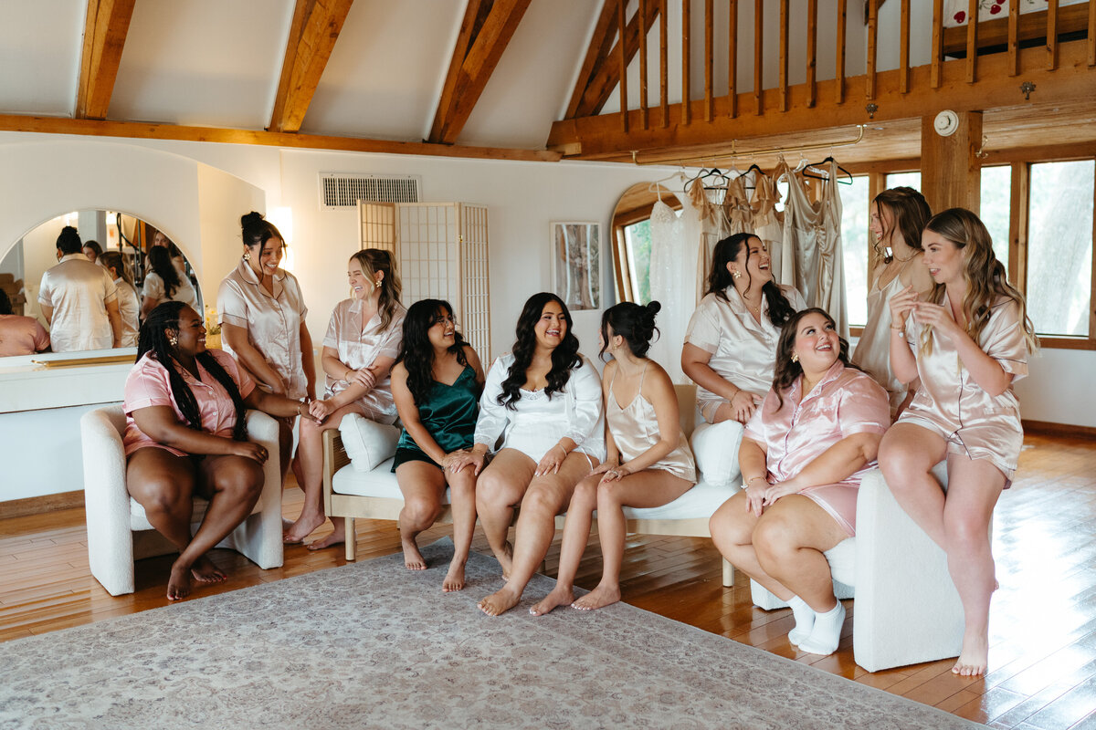  Bridesmaids lounging in robes before the wedding at Uliana Estate, a modern wedding venue in Lakeland FL.