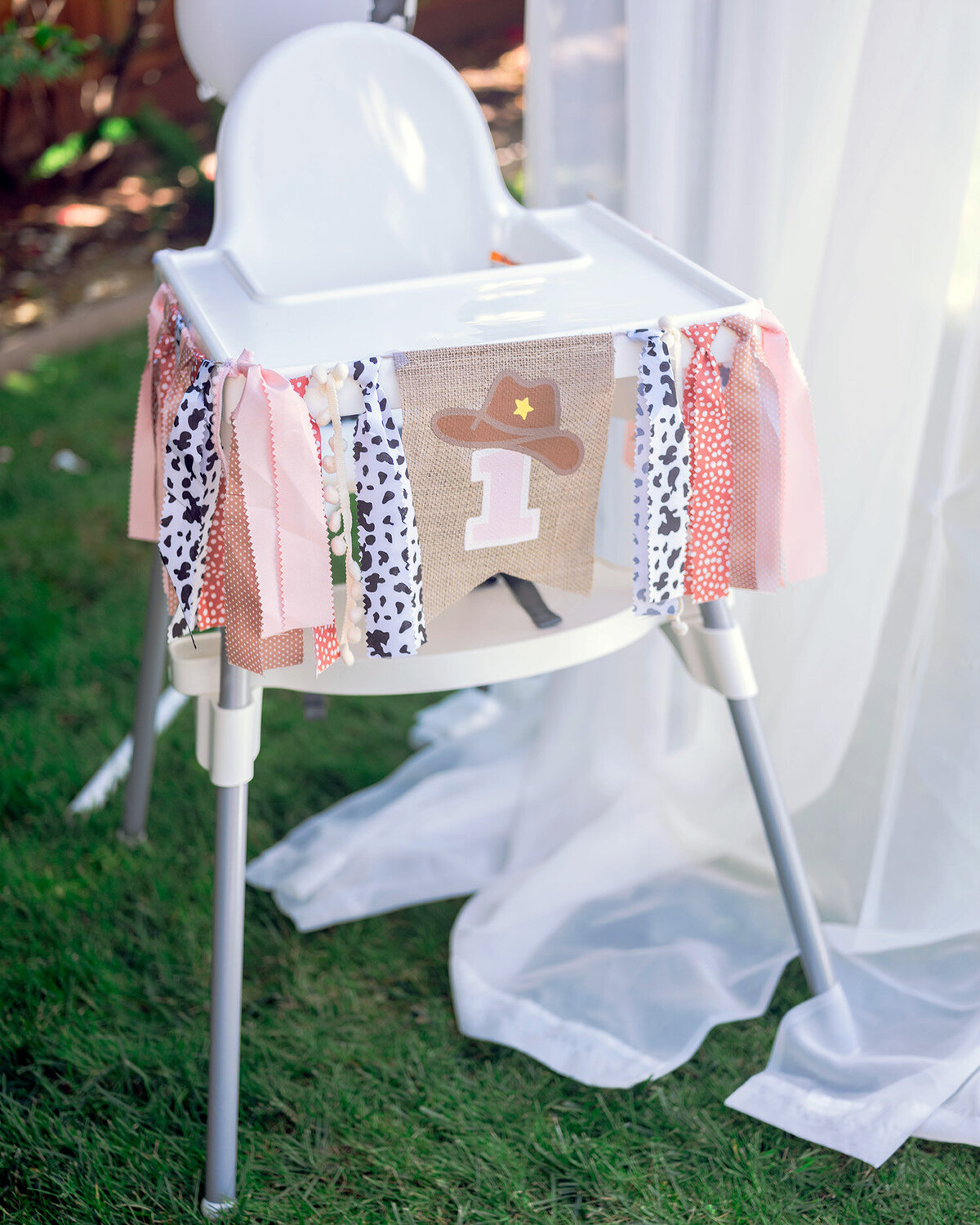 Decorated baby high chair at a first birthday party in the San Francisco Bay Area, captured by a first birthday party photographer.