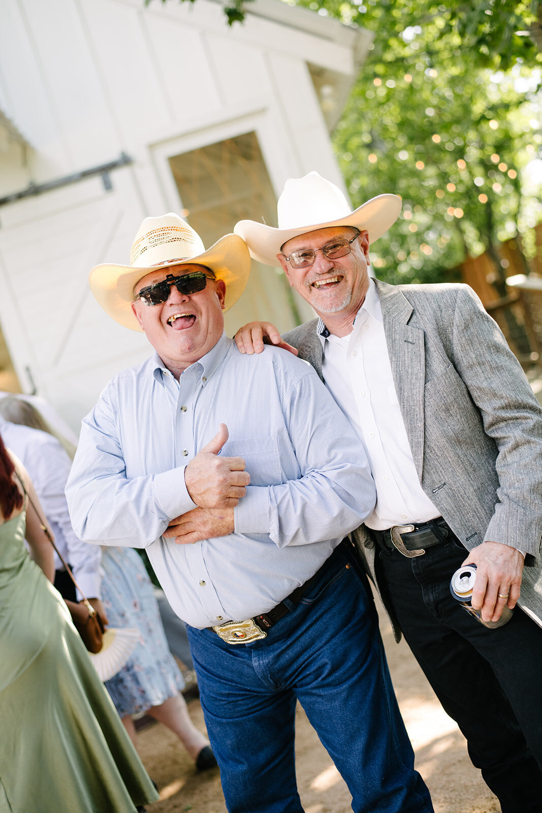 Guests laughing during a heartfelt toast at a Denver wedding reception, captured in an unposed, documentary style.