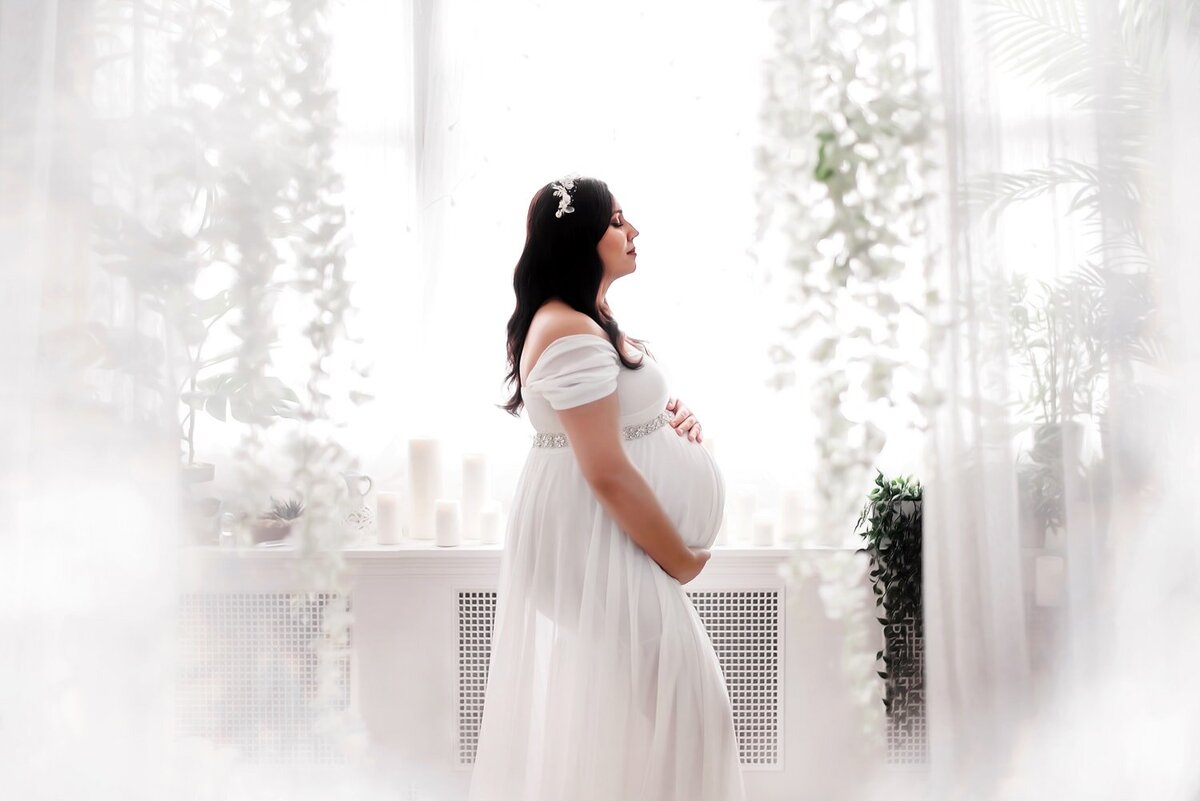 vancouver-studio-maternity-photography_white-dress-curtains-flowers-rhinestone-belt