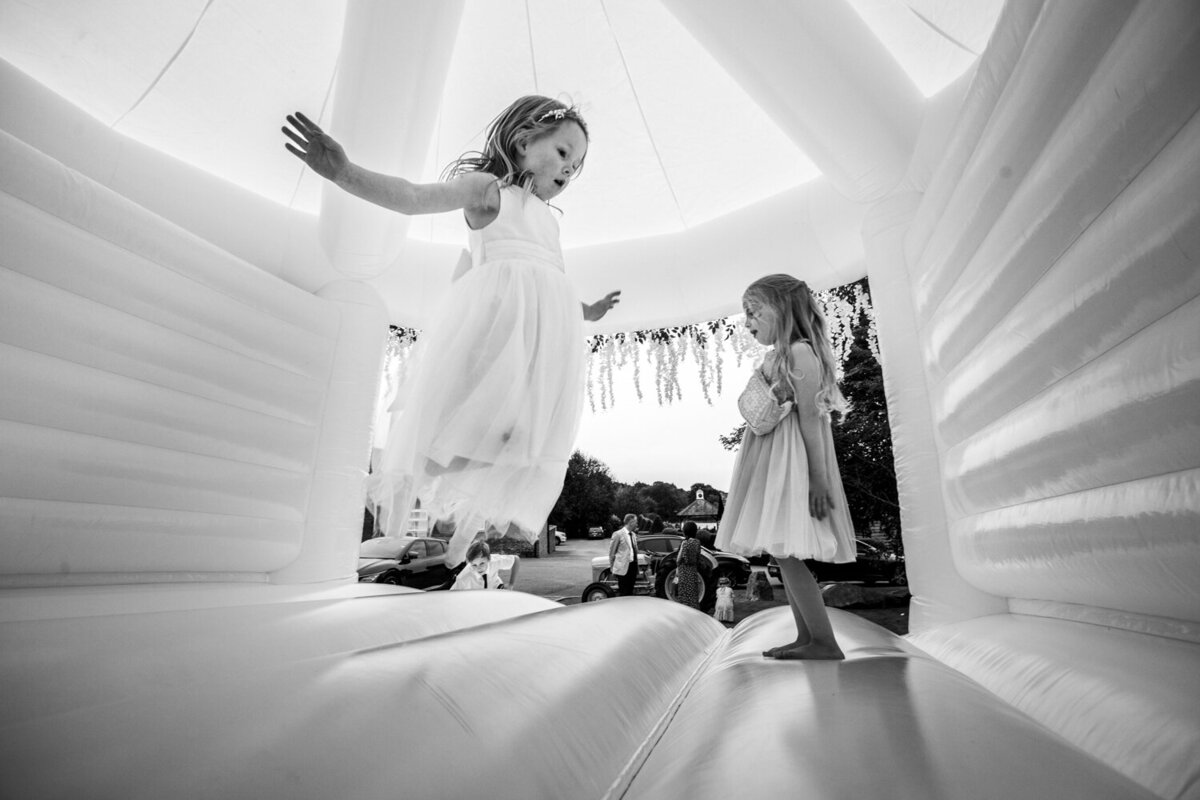 flower girl jumping on bouncy castle