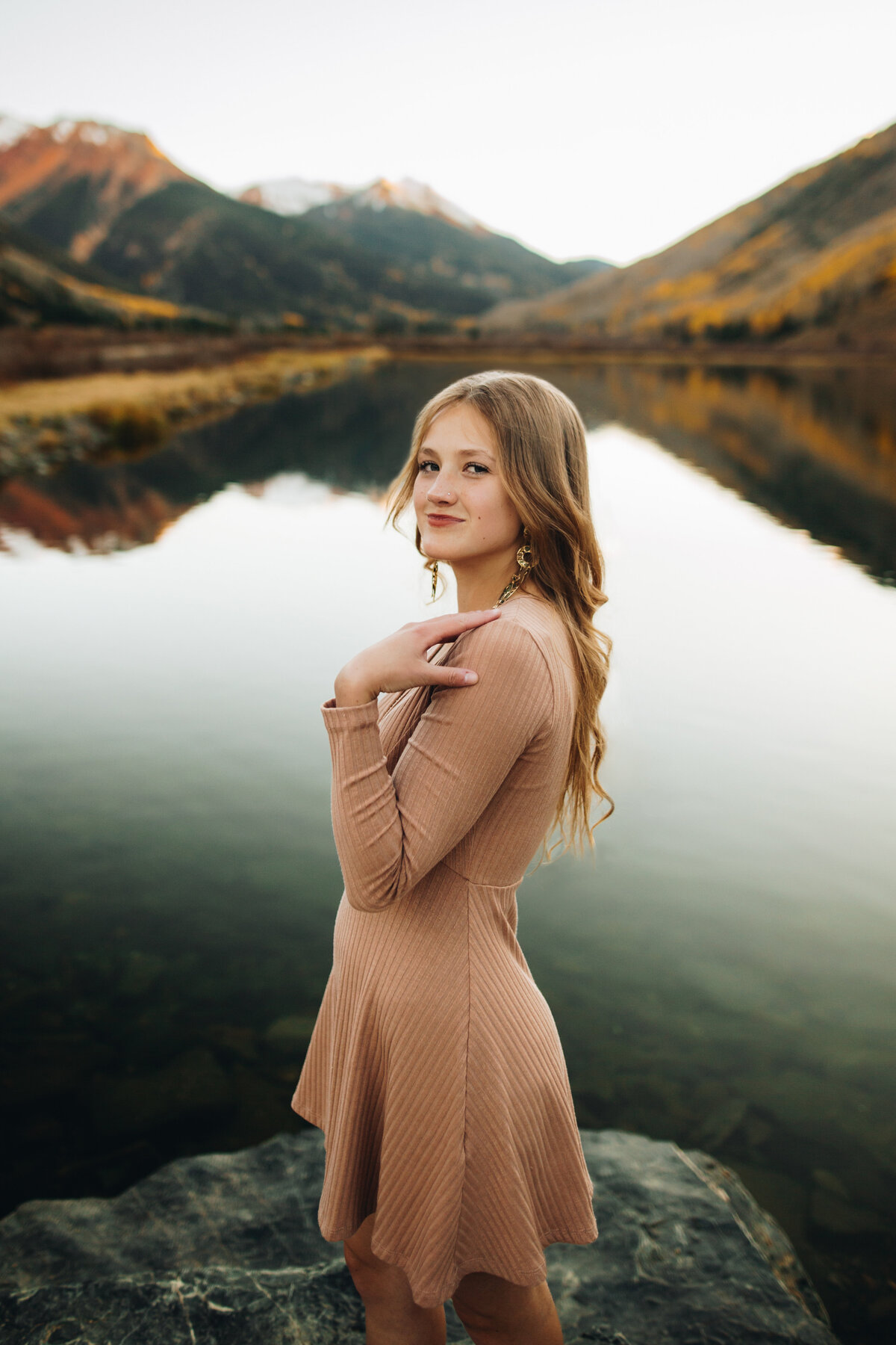 Daytona poses in a lake for her Ouray senior pictures.