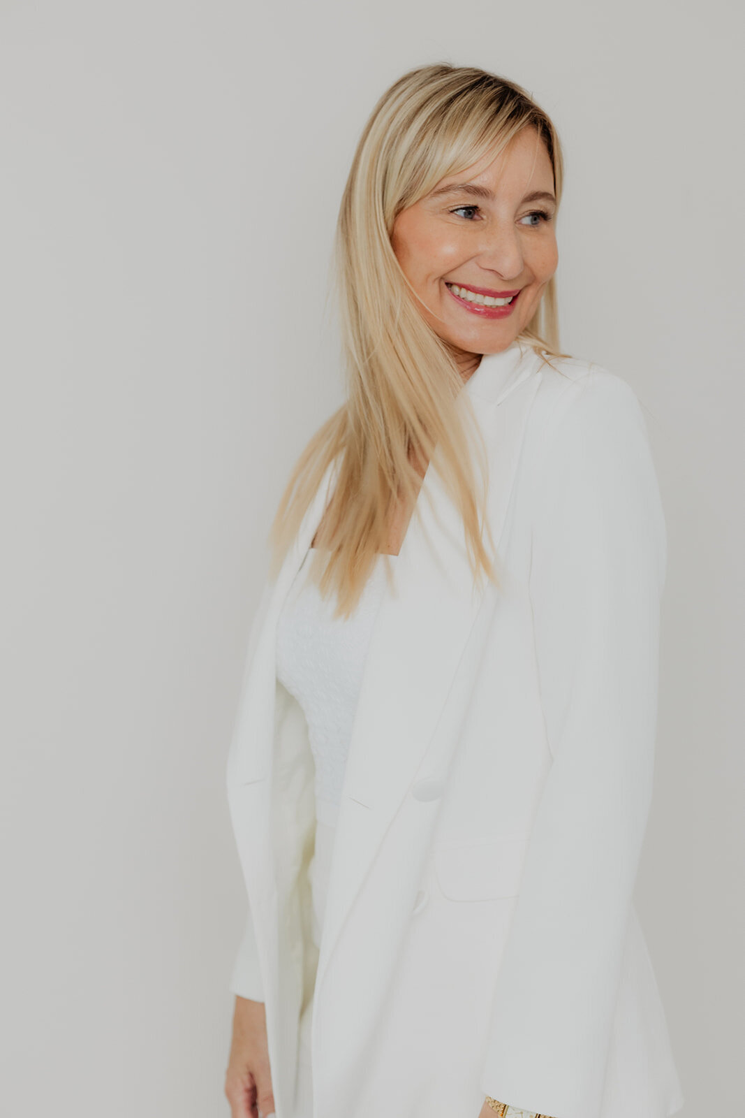 professional headshot of woman in white