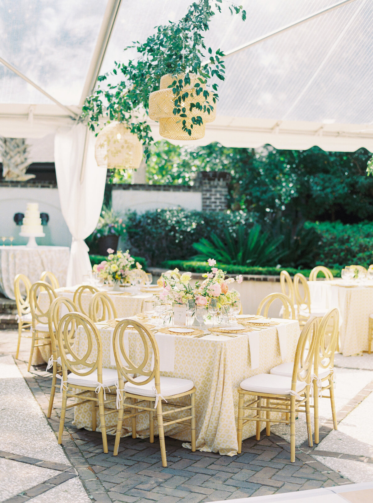 Thomas Bennett House wedding reception with hanging wicker lights and greenery.  Pink and yellow flowers.