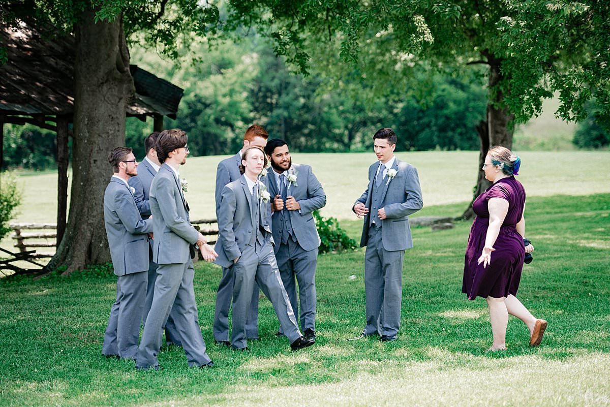 Mahlia giving directions to the groomsmen during photos at Grace Valley Farm