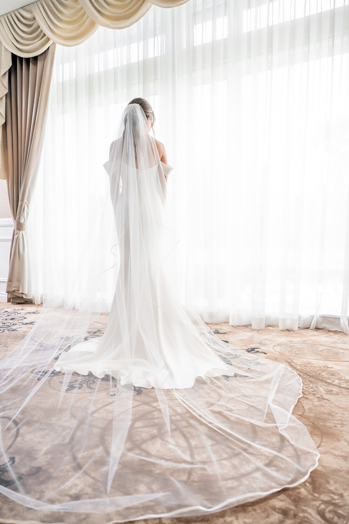 bride posing in window of ballroom at southpointe golf club
