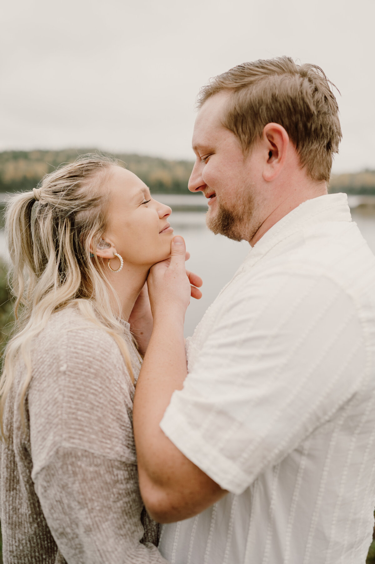 boy hold girl's chin