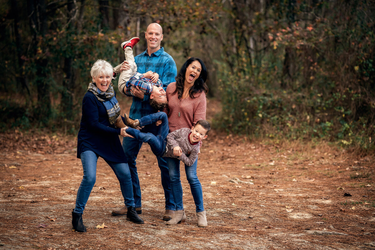 A family is being goofy and laughing during their family photoshoot in Newnan.