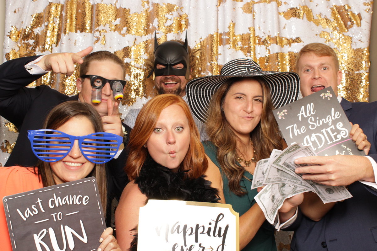 family having fun in photo booth at a wedding