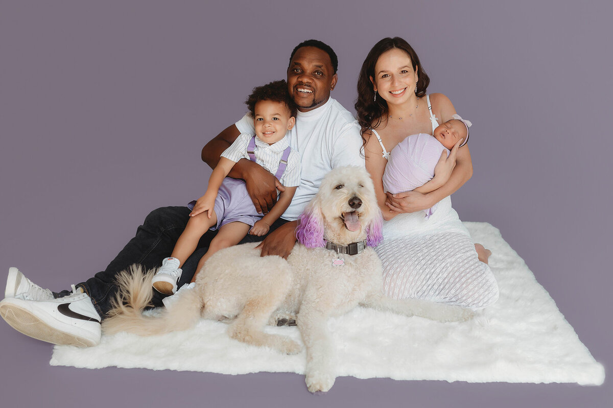 Family poses for Newborn Portraits in Charleston Newborn Photography Studio.