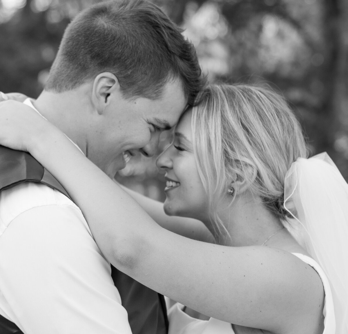 Bride and Groom smiling at each other during their first dance.