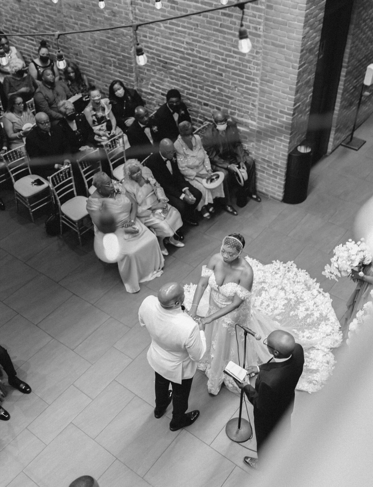 black wedding couple with lace wedding dress, blusher veil, ceremony at Garden Theater Detroit