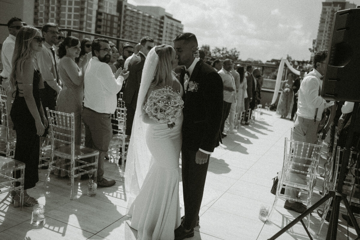black and white ceremony exit kiss