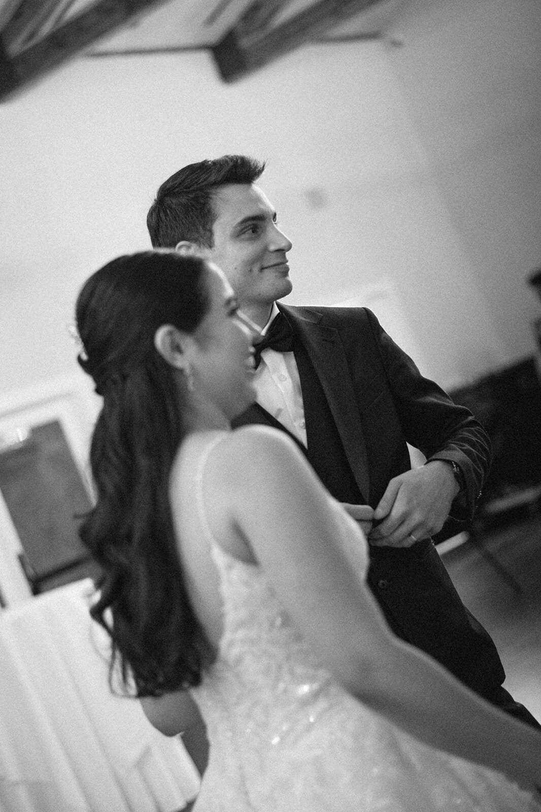 Bride and groom exchanging a joyful glance during their Denver wedding reception, photographed in a documentary style.