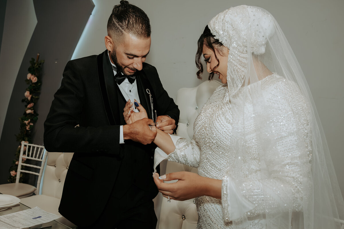 Groom Helping Bride with Jewelry – Emotional Arabic Wedding Moment in Los Angeles