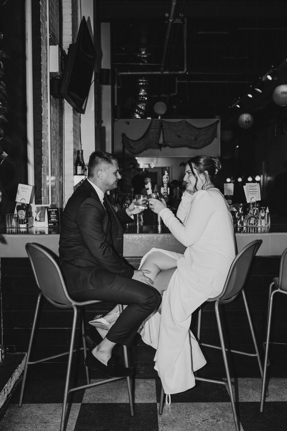 Couple enjoy a drink with direct flash portrait at Good Company