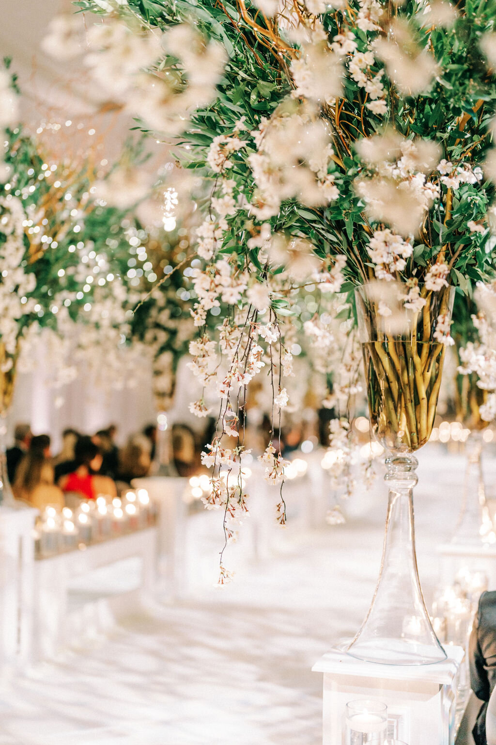 Close up of the glass vase holding the flowers at the wedding reception. 