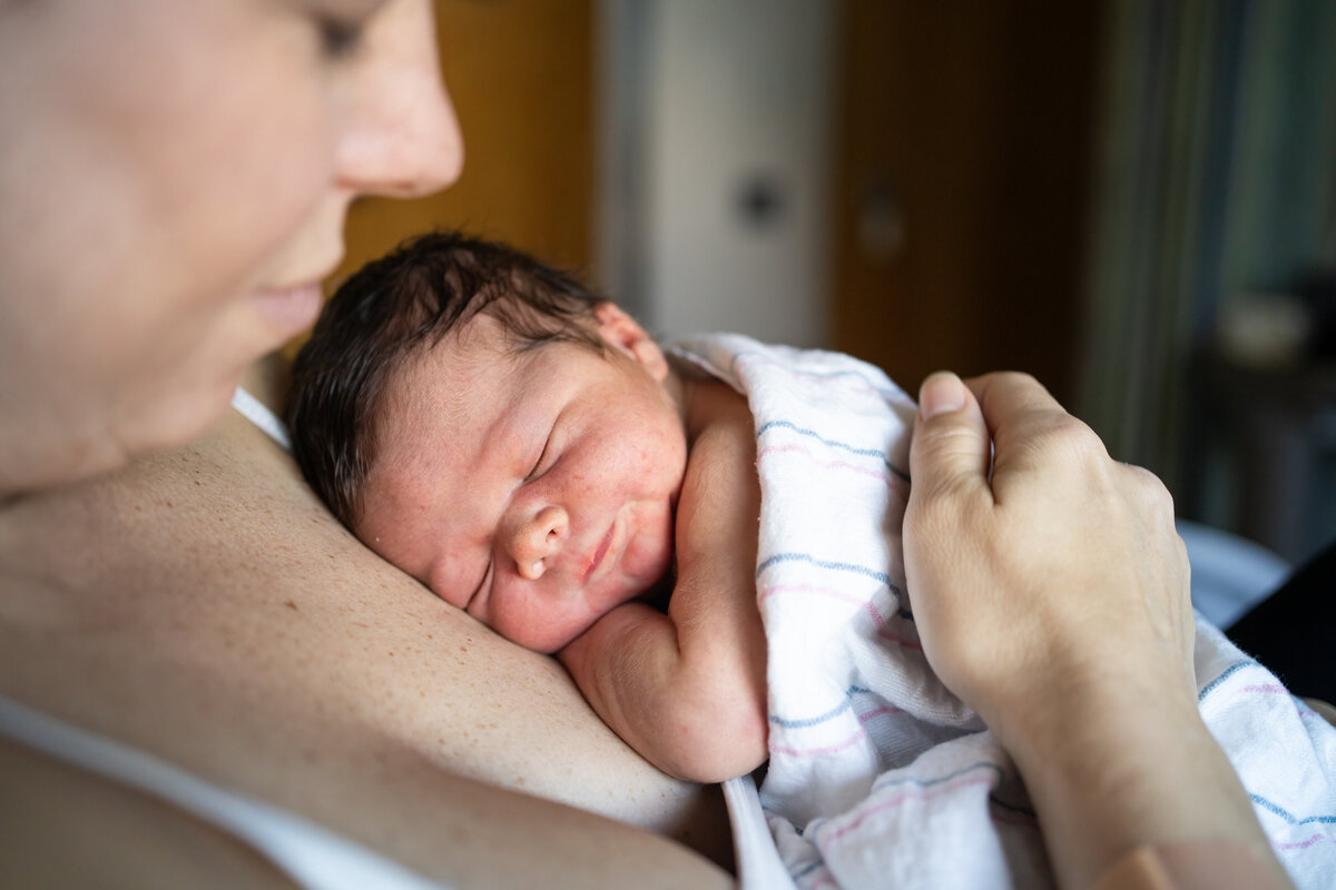 Baby boy snuggled up doing skin to skin  with mom