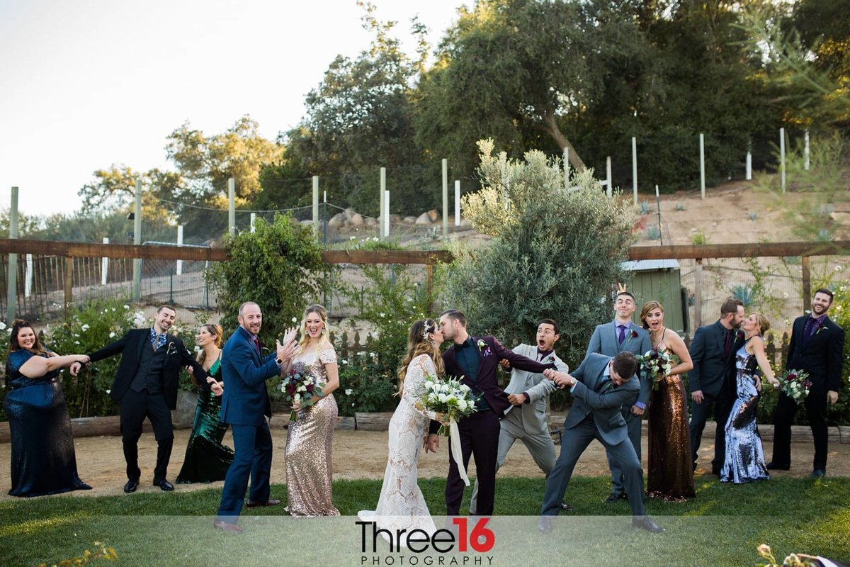Bridal party acting silly during the couples kiss