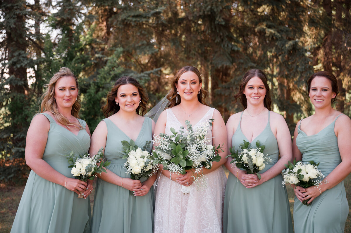 photo of bride and her bridesmaids posing for the camera 